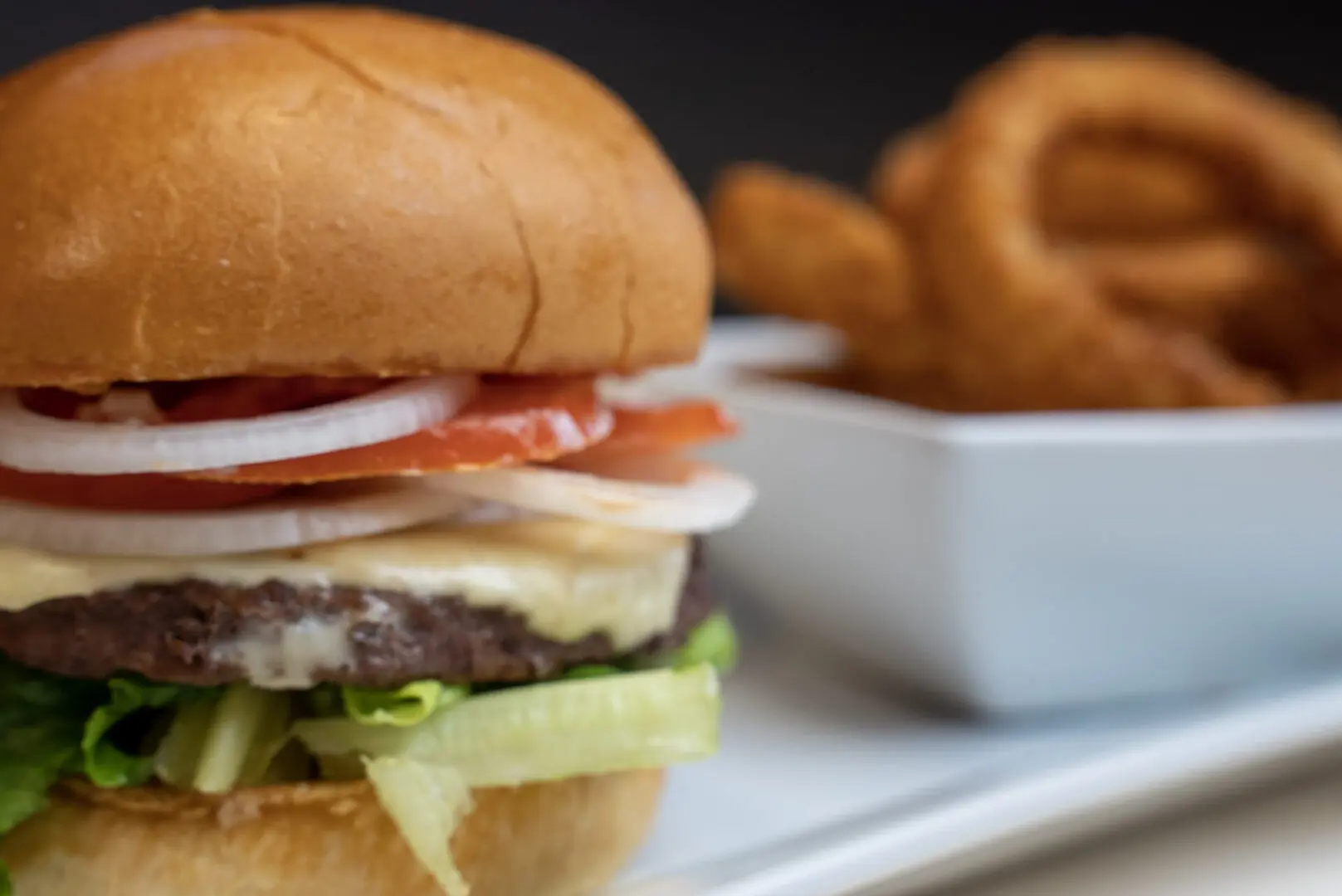 A close up of a hamburger on top of a bun